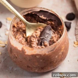 Chocolate overnight oats in jar with spoon.