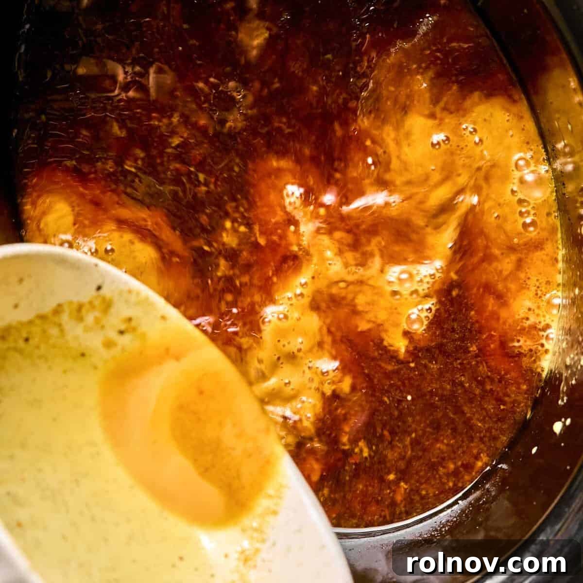 Sticky Honey Sriracha Slow Cooker Chicken 9 Cornstarch slurry being poured into slow cooker.