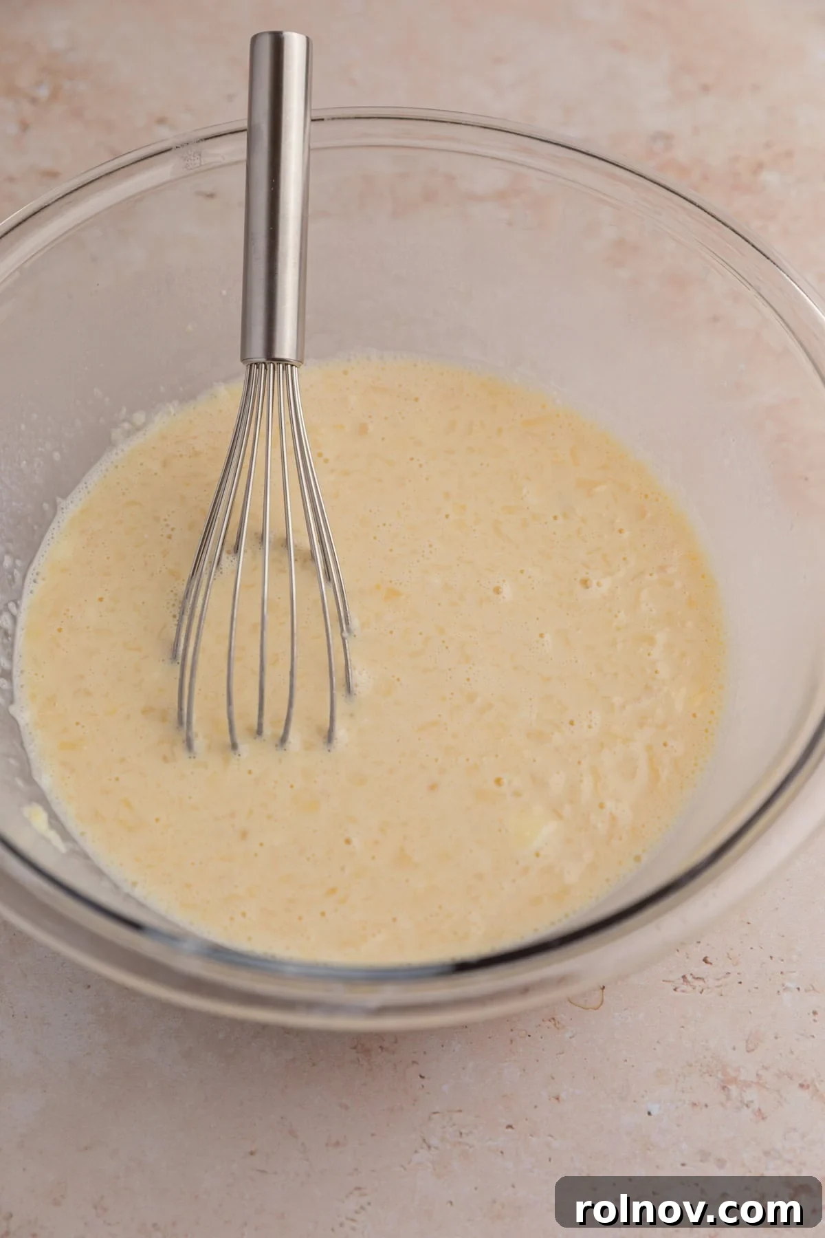 Sheet-Pan Apple Pancakes with Cinnamon 5 Whisk in wet ingredients in bowl.