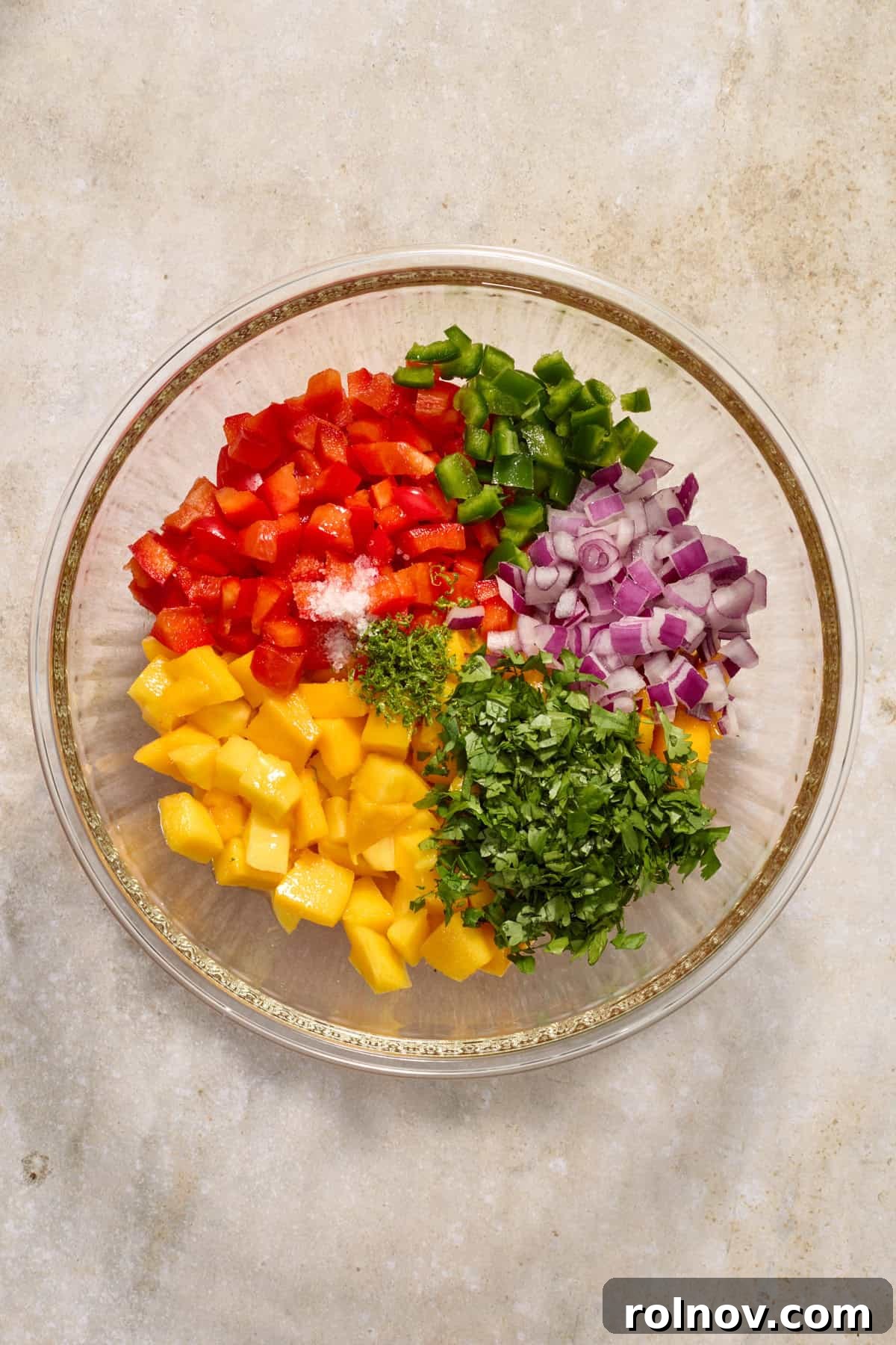 Crispy Baja Fish Tacos with Fresh Mango Salsa 5 Diced mango, onion, red bell pepper, cilantro and other ingredients in glass mixing bowl.