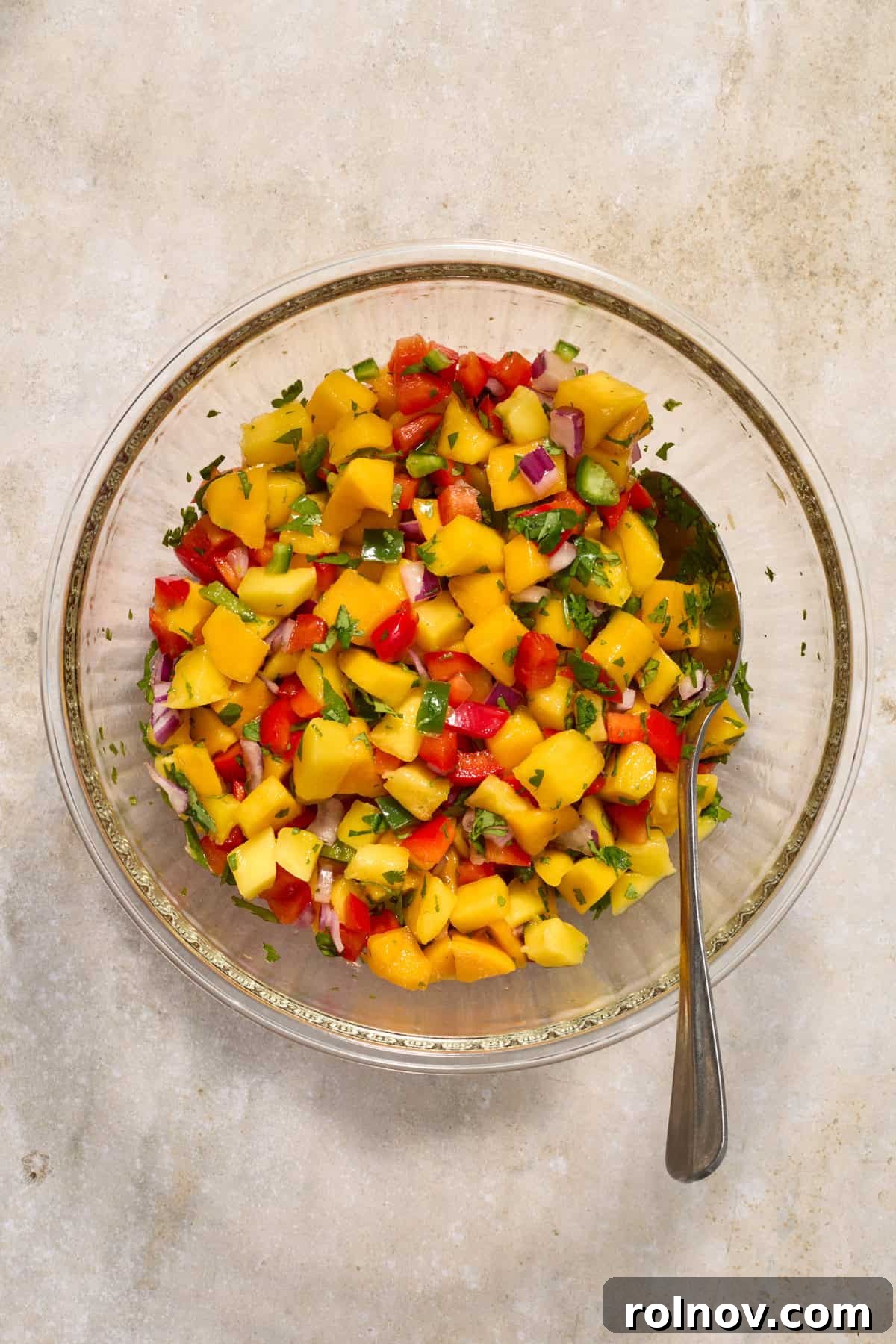 Crispy Baja Fish Tacos with Fresh Mango Salsa 6 Mango salsa in glass bowl with spoon.
