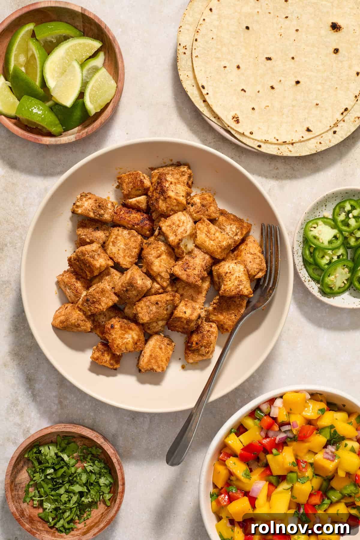 Crispy Baja Fish Tacos with Fresh Mango Salsa 10 Fish cubed and cooked in bowl with serving spoon.