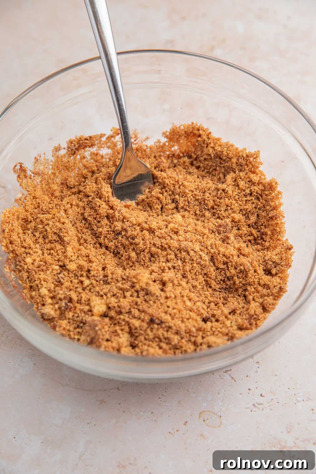 Brown sugar cinnamon mixture in bowl with fork.