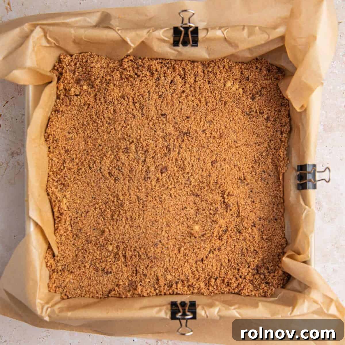 Cinnamon brown sugar mixture in pan lined with parchment.
