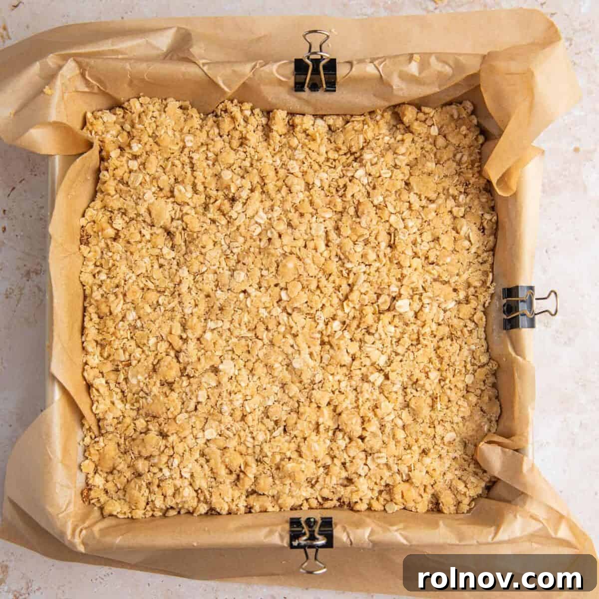 Crumble topped cinnamon brown sugar bars in pan before baking.