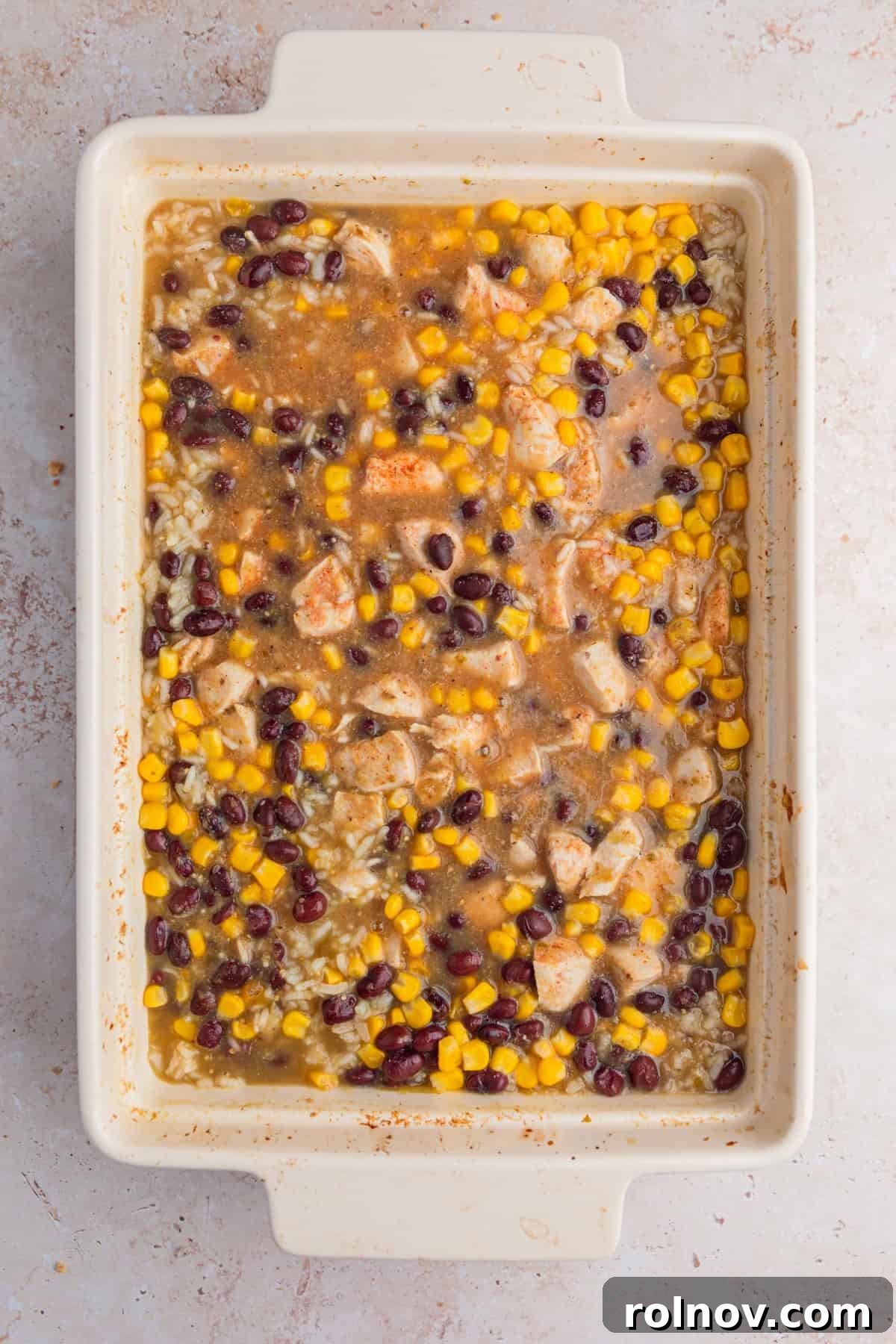 Baked salsa verde chicken with beans and corn.