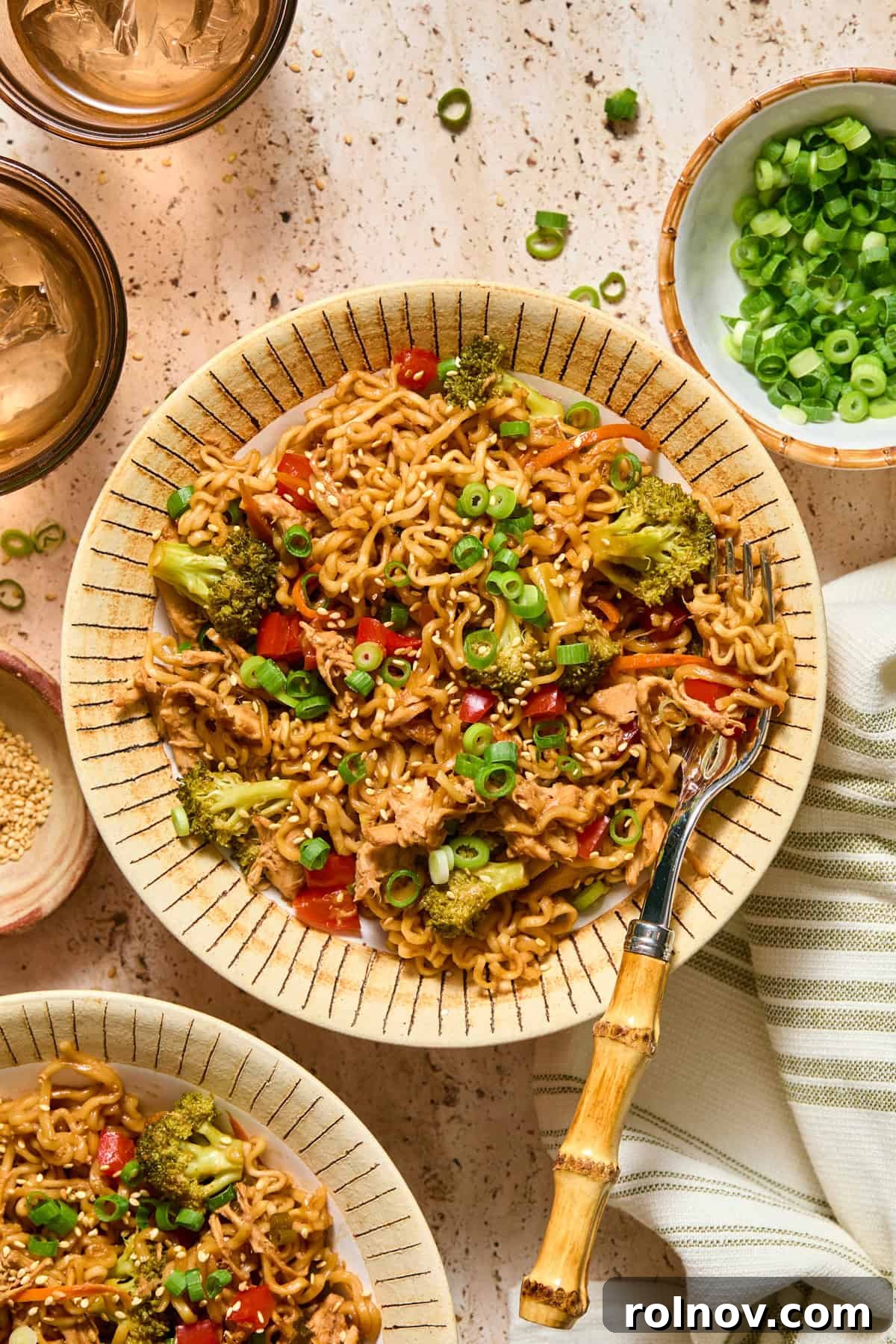 Ramen chicken and veggies in bowl with fork.