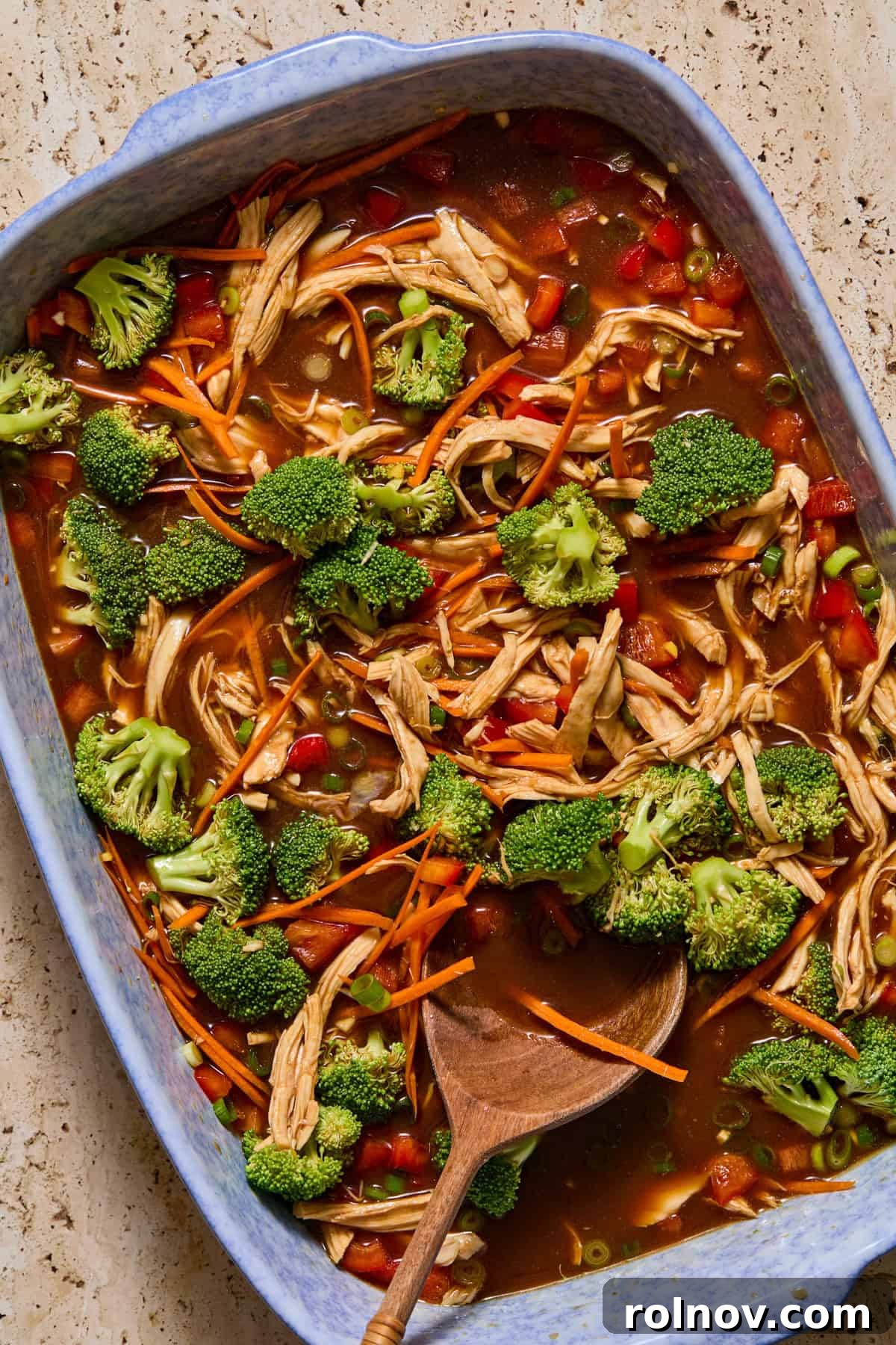 Vegetables and chicken stirred into sauce for ramen bake.