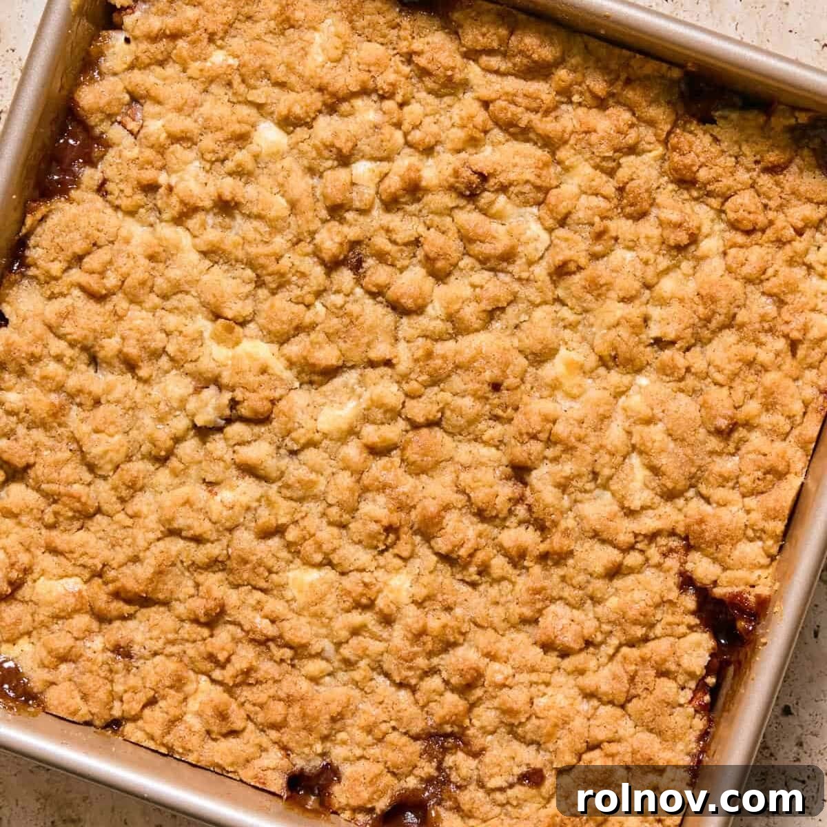 Apple cinnamon cream cheese cobbler baked in pan.