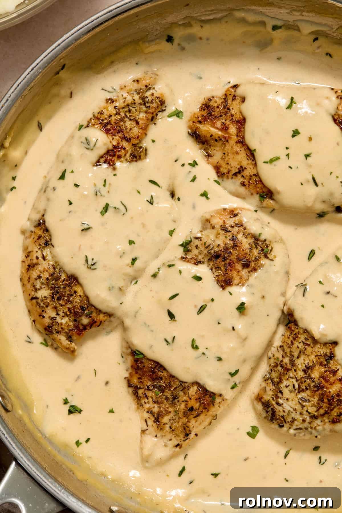Creamy Garlic Parmesan Chicken Recipe 2 Garlic parmesan chicken breast in pan with cream sauce.