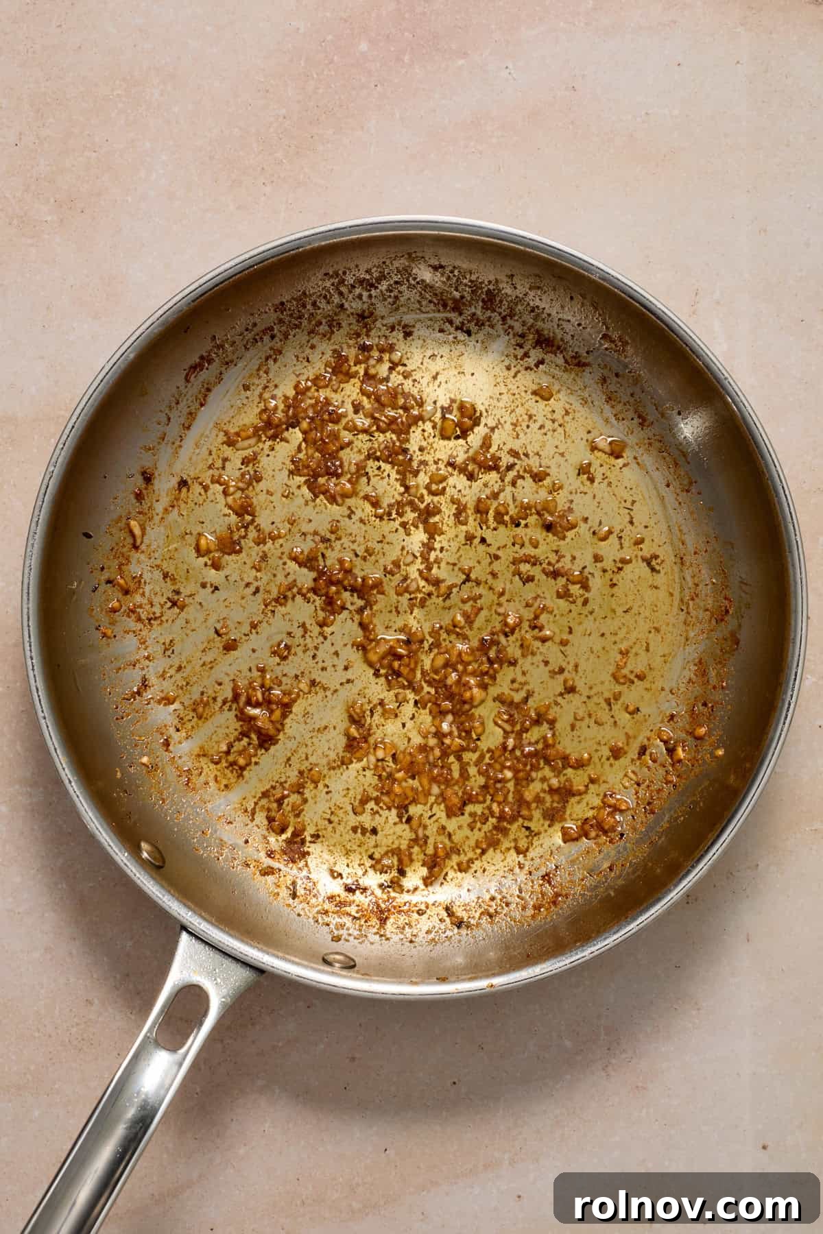 Creamy Garlic Parmesan Chicken Recipe 7 Skillet with garlic being sautéd.