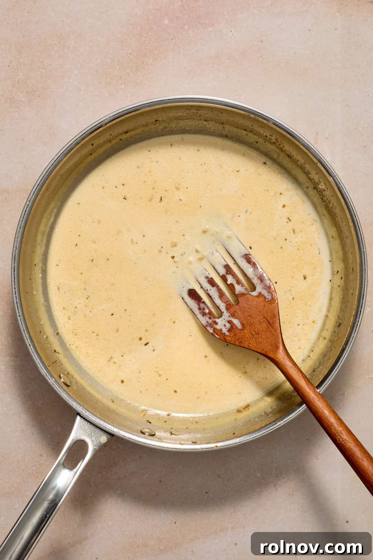 Creamy Garlic Parmesan Chicken Recipe 8 Cream cheese and cream added to pan with spatula.