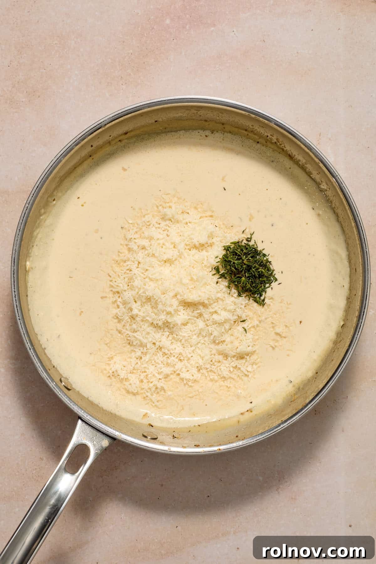 Creamy Garlic Parmesan Chicken Recipe 9 Parmesan and seasoning added to pan.