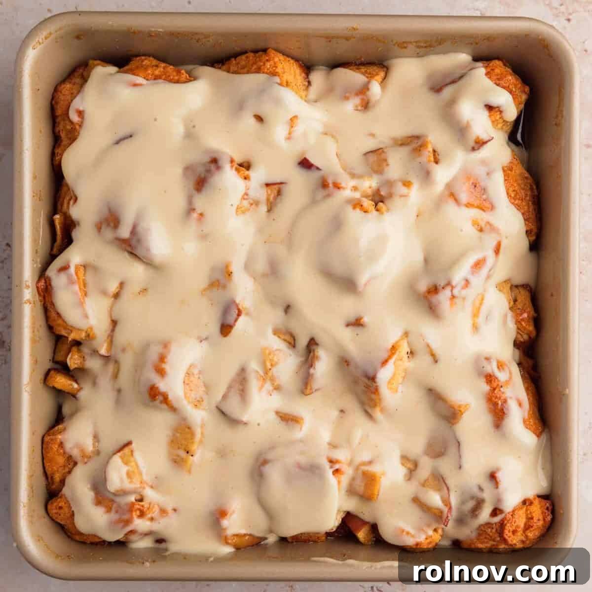 Warm Apple Cinnamon Biscuit Casserole 9 Apple pie biscuit bake in pan with icing.