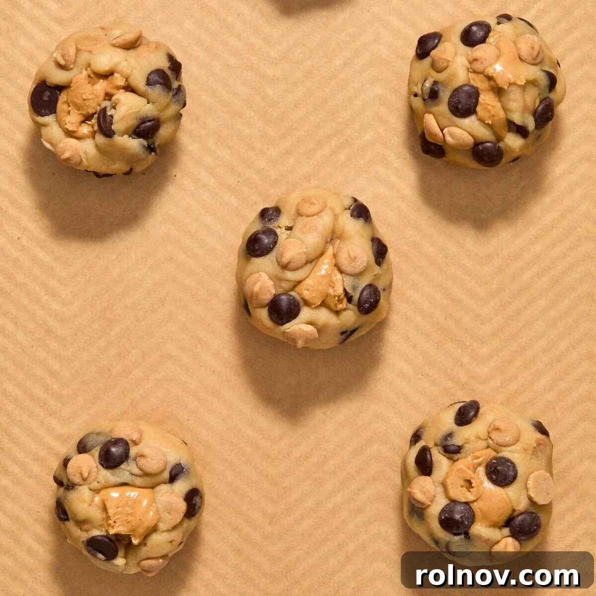 Peanut butter stuffed cookie dough on pan.