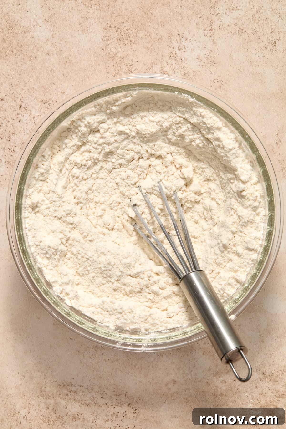 Dry ingredients combined in bowl with whisk.