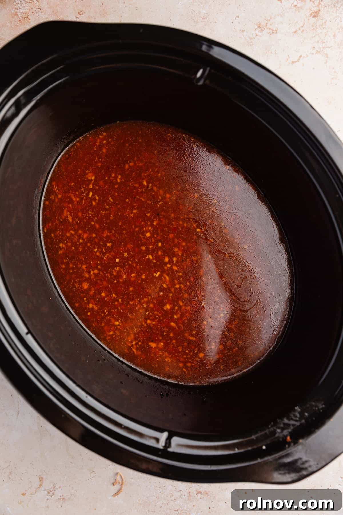 Honey Garlic Pork Tenderloin in the Slow Cooker 8 Sauce with cornstarch slurry in slow cooker.