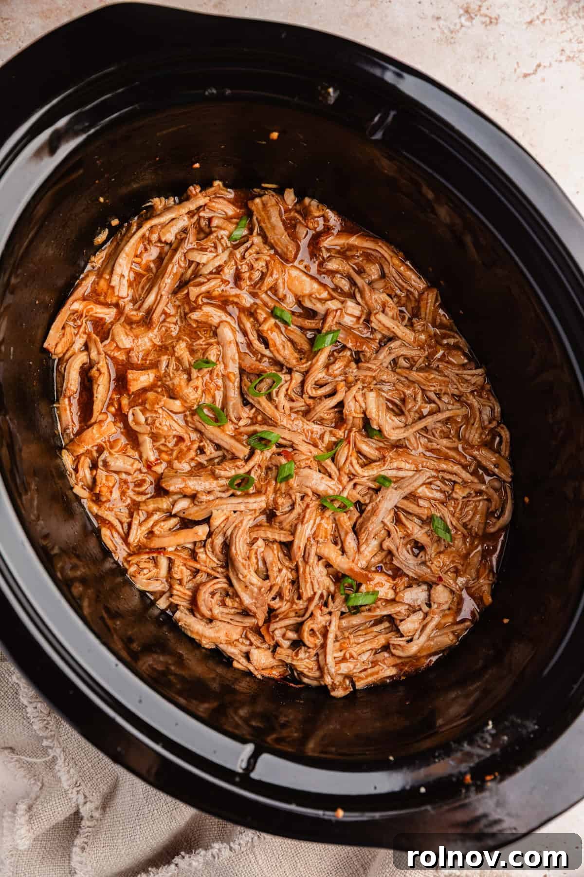Honey Garlic Pork Tenderloin in the Slow Cooker 10 Pulled honey garlic pork tenderloin in crockpot.