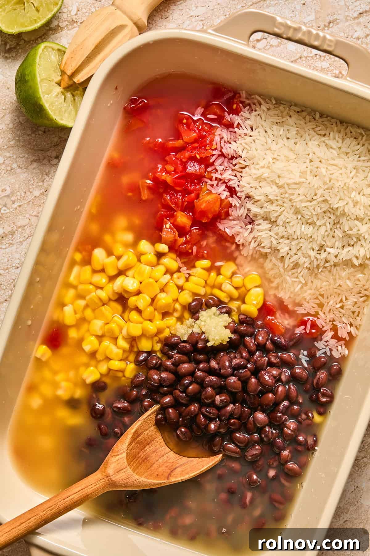 Cheesy Taco Chicken and Rice Casserole 5 Baking pan with beans, corn, broth, lime juice and rice