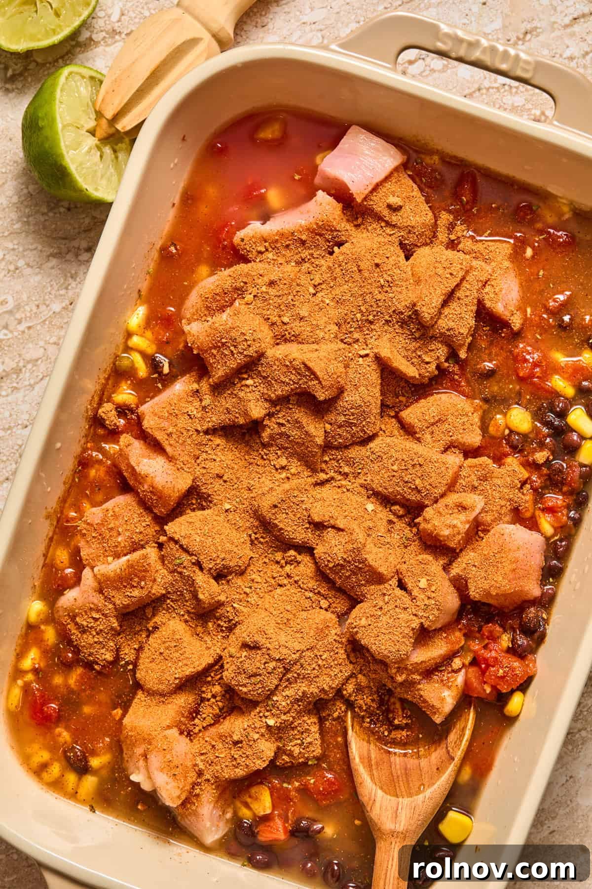 Cheesy Taco Chicken and Rice Casserole 6 Chicken breast cubed in baking dish with taco seasoning