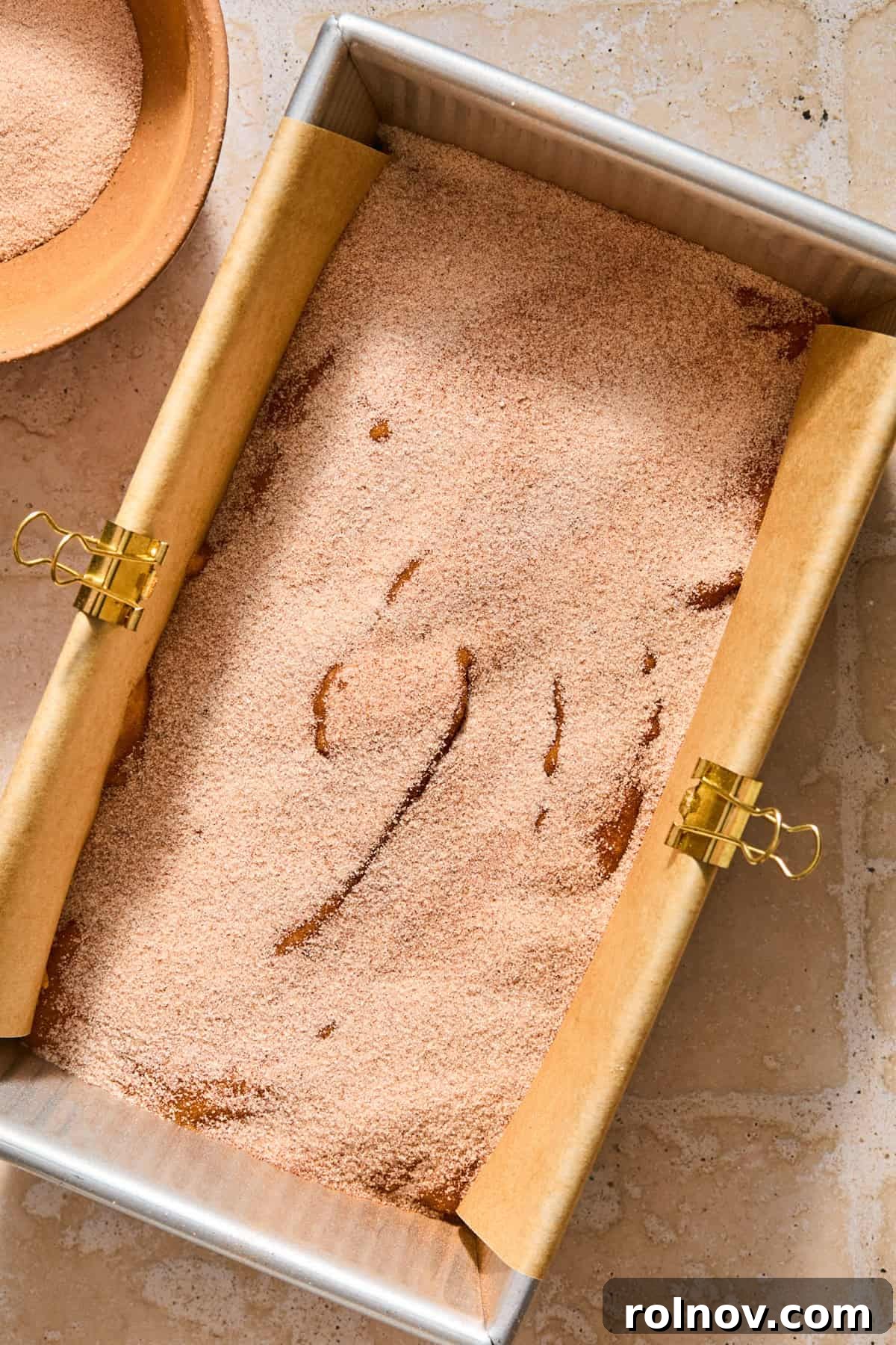 Cinnamon Pumpkin Bread with Cream Cheese Swirl 11 Pumpkin bread batter in bread pan topped with cinnamon sugar mix.