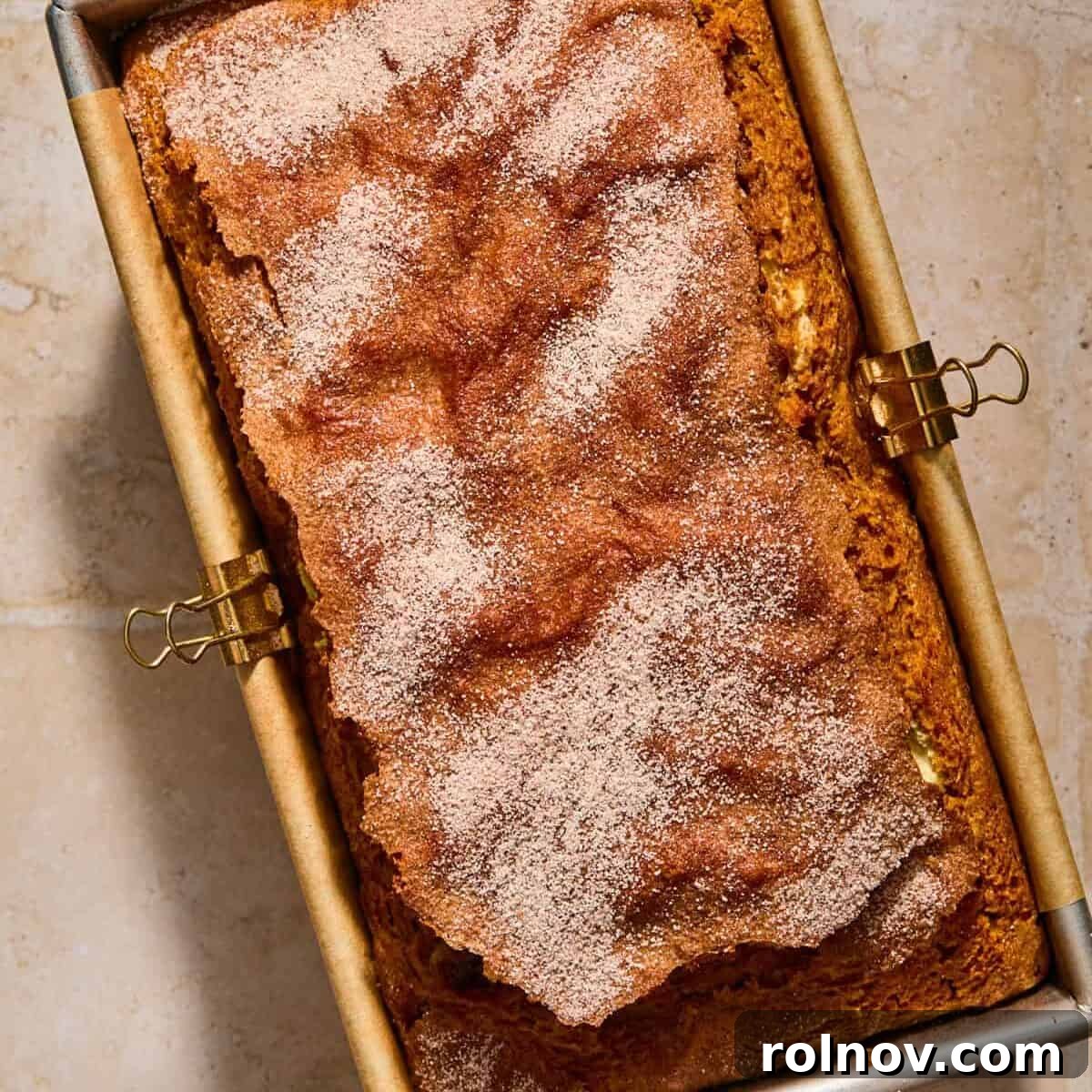 Cinnamon Pumpkin Bread with Cream Cheese Swirl 14 Baked pumpkin bread in pan topped with cinnamon and sugar.