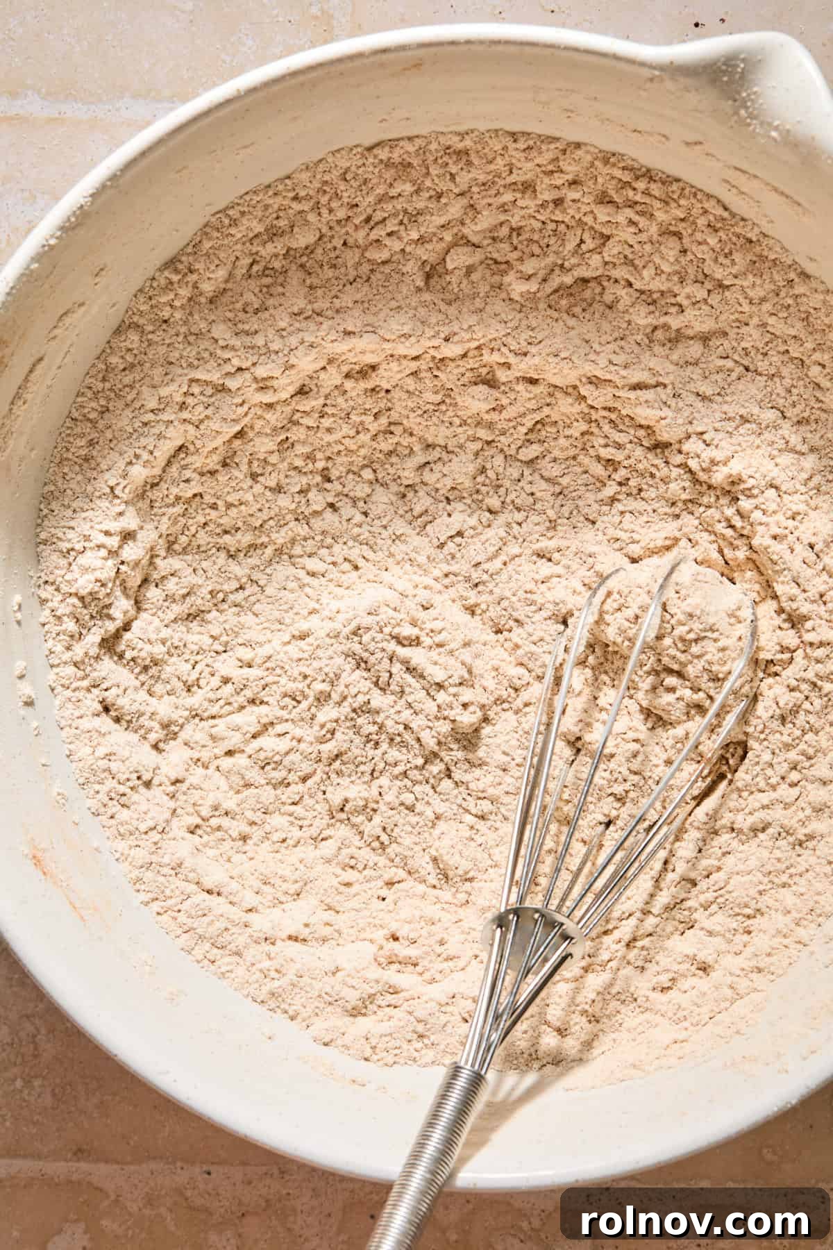Cinnamon Pumpkin Bread with Cream Cheese Swirl 5 Dry ingredients in bowl with whisk.